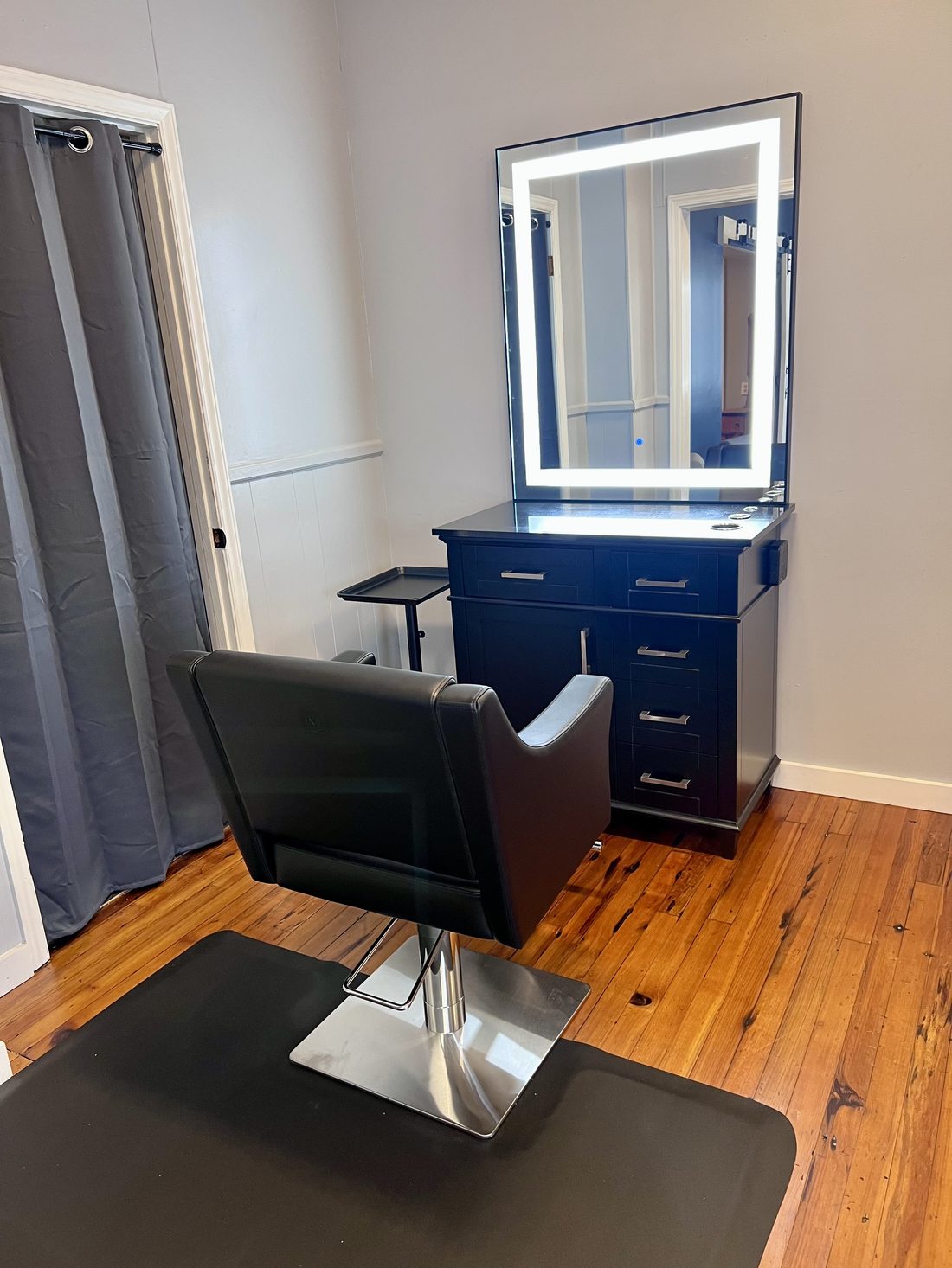 Styling station with lighted mirror and cabinetry